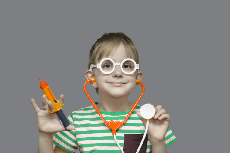 little girl holding a toy needle and stethoscope, pretending to be a doctor